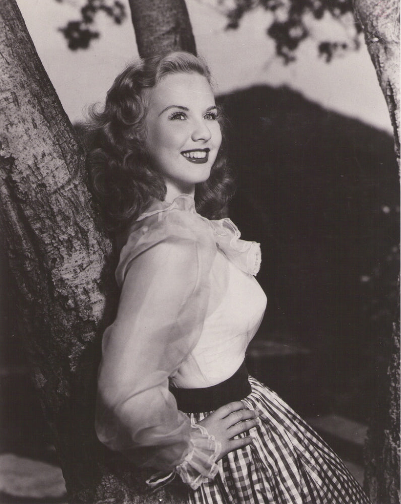 Deanna Durbin leaning on tree photo print, classic Hollywood elegance.