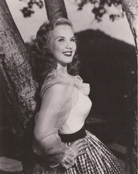 Deanna Durbin leaning on tree photo print, classic Hollywood elegance.