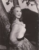 Deanna Durbin leaning on tree photo print, classic Hollywood elegance.