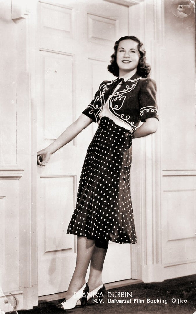 Deanna Durbin Holding Doorknob Photo Print showing vintage Hollywood charm.