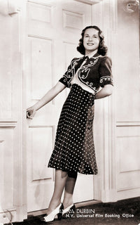 Deanna Durbin Holding Doorknob Photo Print showing vintage Hollywood charm.