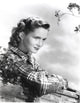 Debbie Reynolds leaning on log in plaid shirt photo print