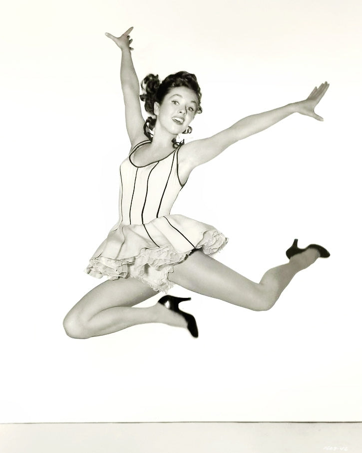 Debbie Reynolds Dancing Pose Photo Print showcasing her elegance in the air.