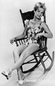 Debbie Reynolds sitting in a rocking chair photo print