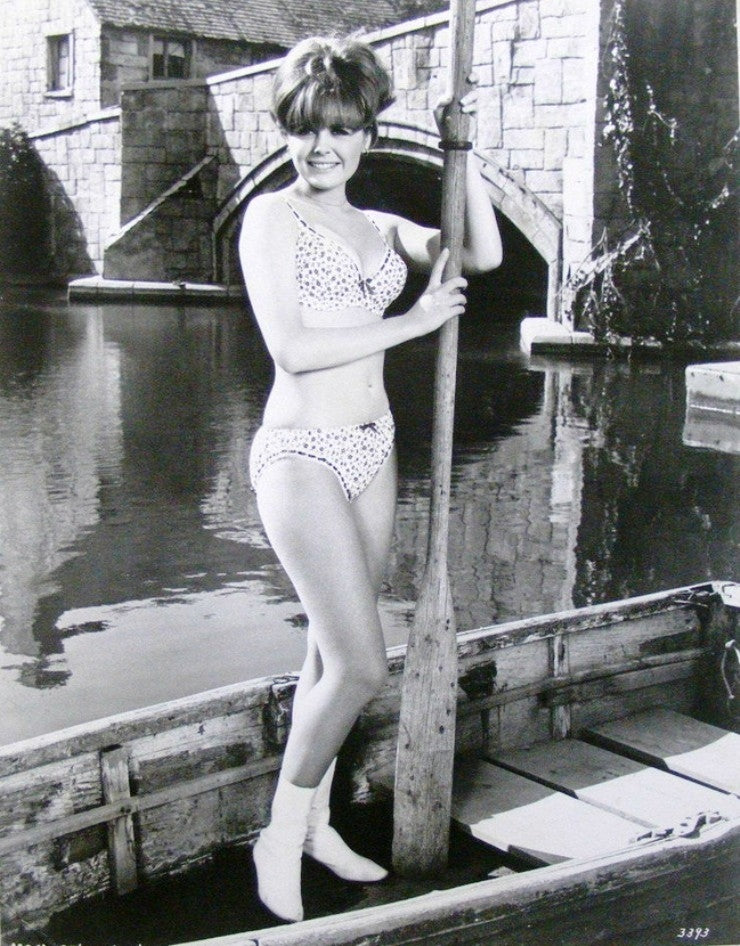 Deborah Walley holding a boat paddle in a captivating photo print.
