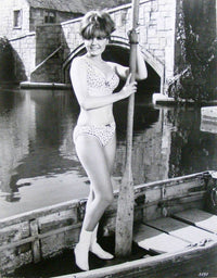 Deborah Walley holding a boat paddle in a captivating photo print.