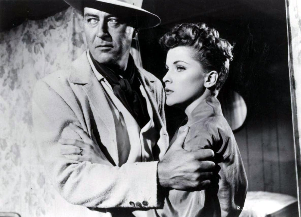 Debra Paget holding onto man's arm photo print