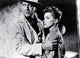 Debra Paget holding onto man's arm photo print