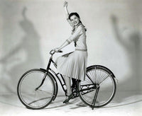 Debra Paget Riding a Bicycle Photo Print showcasing vintage photography art.