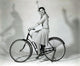 Debra Paget Riding a Bicycle Photo Print showcasing vintage photography art.
