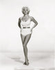 Diana Dors in a stunning white one piece photo print.