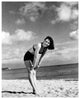 Vintage photo print of Donna Reed leaning over on the beach.