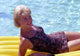 Doris Day relaxing on a pool float - Vintage photo print