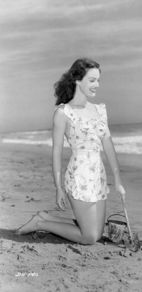 Dorothy Hart Kneeling on Beach Photo Print showcasing serene coastal beauty.
