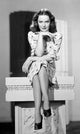 Dorothy Hart posed on pedestal photo print showcasing vintage elegance.