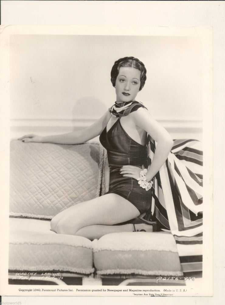 Dorothy Lamour photo print kneeling on couch with hand on hip.