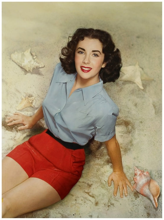 Elizabeth Taylor sitting on beach in blue and red outfit photo print