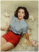 Elizabeth Taylor sitting on beach in blue and red outfit photo print