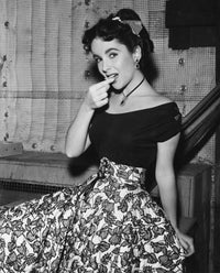 Elizabeth Taylor in a black dress with leaf pattern photo print.