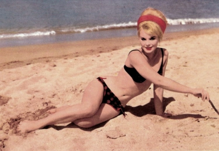 Elke Sommer lounging on the beach in a black bikini photo print.