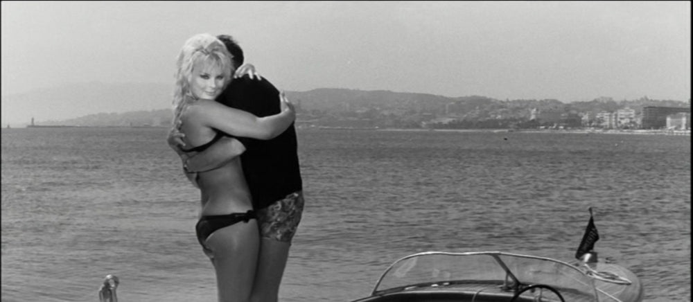 Elke Sommer standing on a boat in a black bikini photo print.
