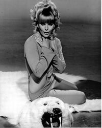 Elke Sommer sitting on bear rug photo print