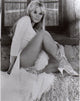 Elke Sommer Sitting on Hay Stack Photo Print showcasing classic beauty.