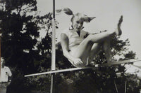 Elke Sommer Jumping Over Pole Photo Print showcasing dynamic motion.