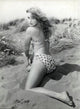 Elke Sommer photo print kneeling in sand wearing polka dot bikini