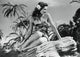 Gene Tierney Sitting Sideways on Rocks Photo Print