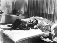 Gene Tierney Laying in Bed Photo Print showcasing classic Hollywood elegance.