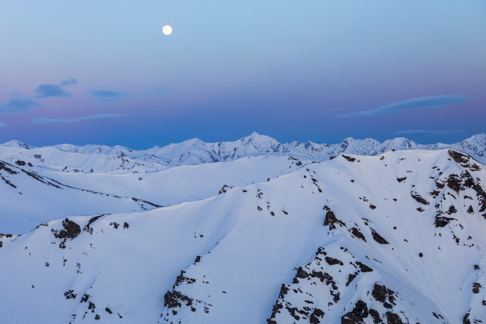 The Moon Rises Over Snowy Mountain Ridges in Alaska by Steven Miley - Fine Art Print