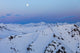 The Moon Rises Over Snowy Mountain Ridges in Alaska by Steven Miley - Fine Art Print