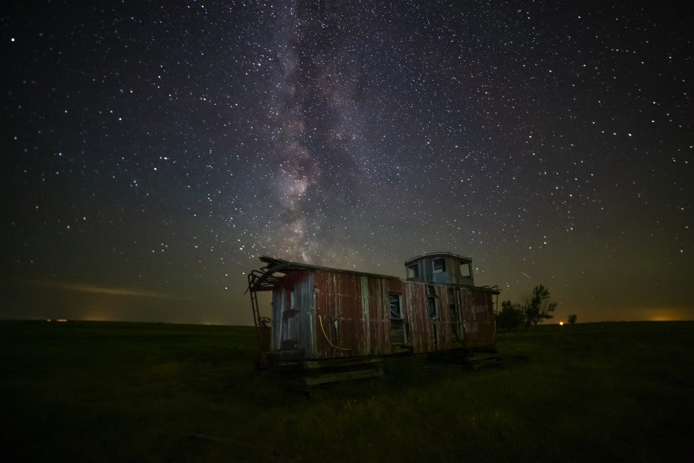 Old Caboose Under Starry Sky Fine Art Print by Michael St. Laurent