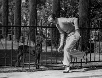 Fred Astaire playing with dog photo print, classic film memorabilia.