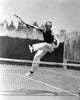 Fred Astaire leaping over a tennis net, photo print