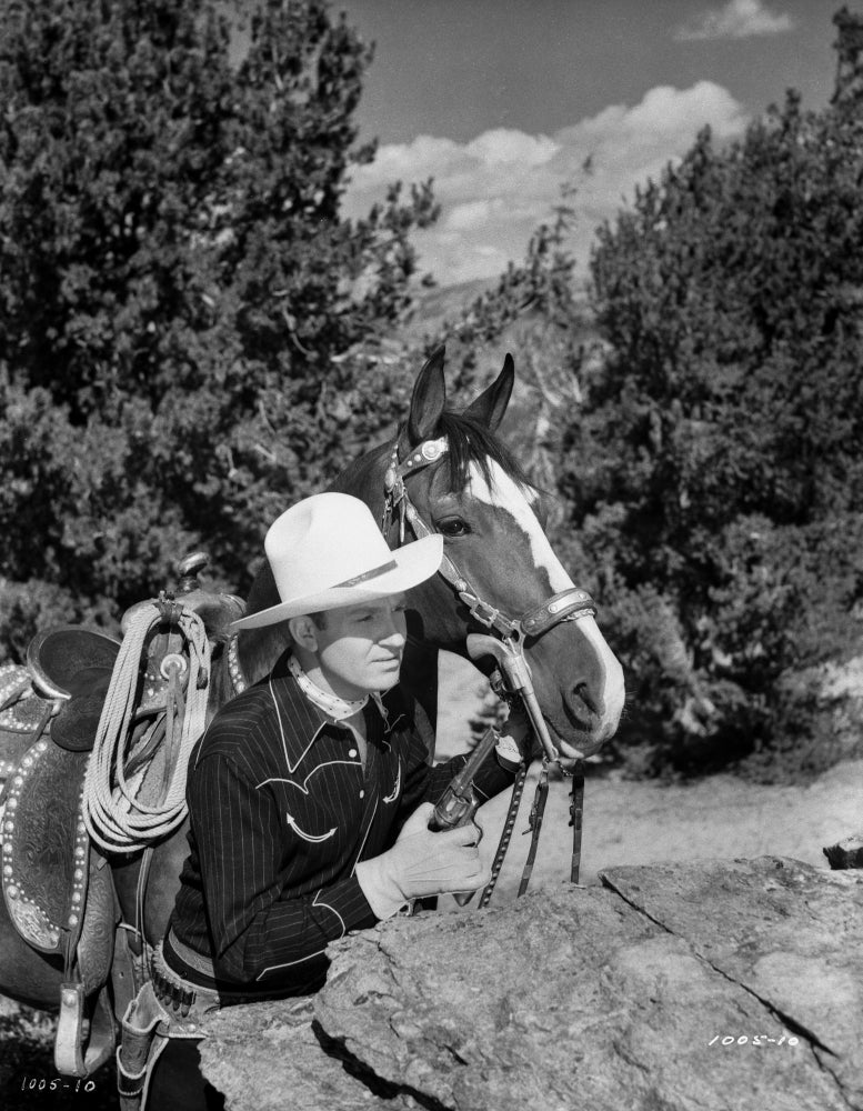 Gene Autry Hiding Behind a Big Rock Photo Print showcasing the iconic cowboy.