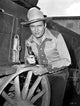 Gene Autry in cowboy attire photo print, showcasing the iconic singing cowboy.