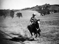Gene Autry Riding a Horse Photo Print showcasing the legendary Singing Cowboy.