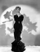 Lucille Ball standing elegantly in a black dress photo print.