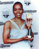 Angela Bassett posed with trophy photo print capturing elegance.
