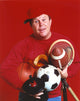 Ned Beatty posed in front of a red background photo print