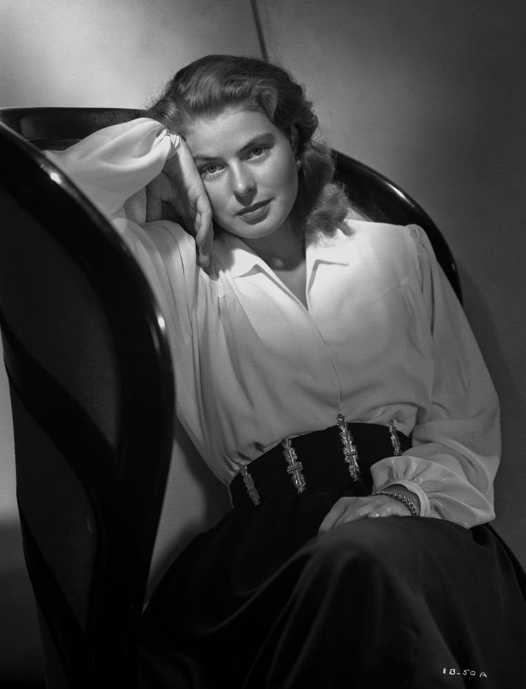 Ingrid Bergman leaning on couch in a white dress photo print