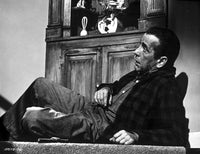 Humphrey Bogart laying down photo print showcasing classic Hollywood charm.