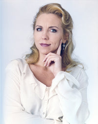 Close up portrait photo of Brett Butler in a white dress.