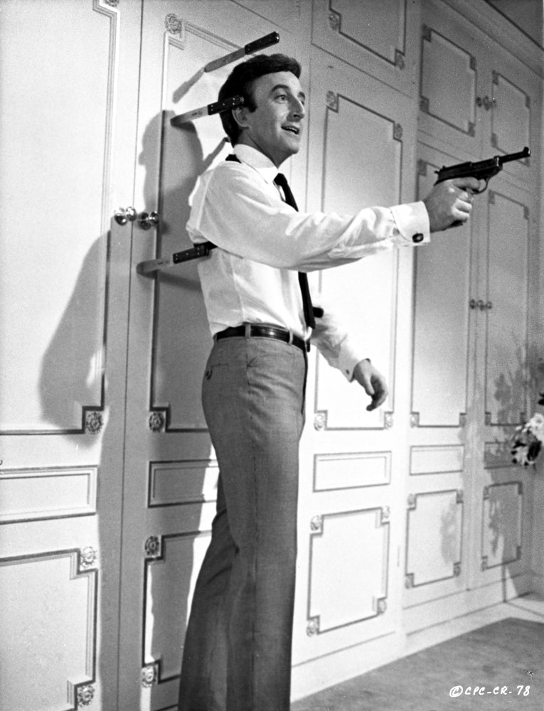 Film still of Peter Sellers holding a gun photo print.