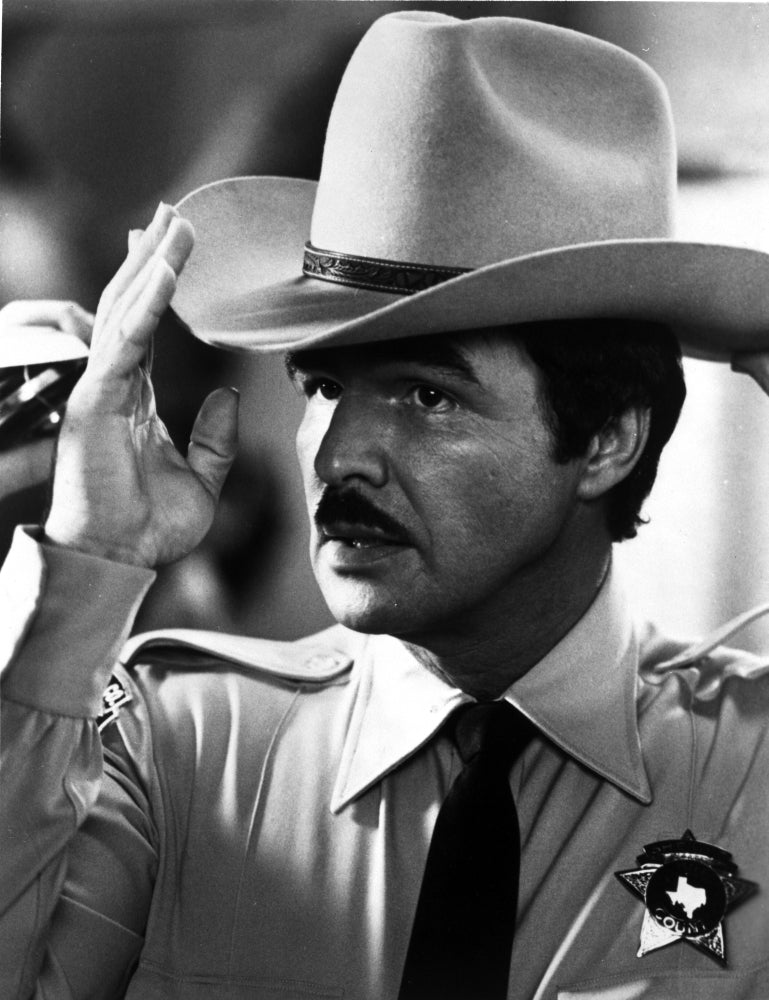Burt Reynolds wearing a police badge and cowboy hat photo print