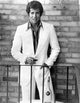 Tony Roberts Photo Print wearing a suit in front of a brick wall.