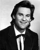 Kurt Russell smiling photo print capturing his charm and charisma.