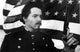 Matthew Broderick in historical costume with pistol in front of American flag photo print